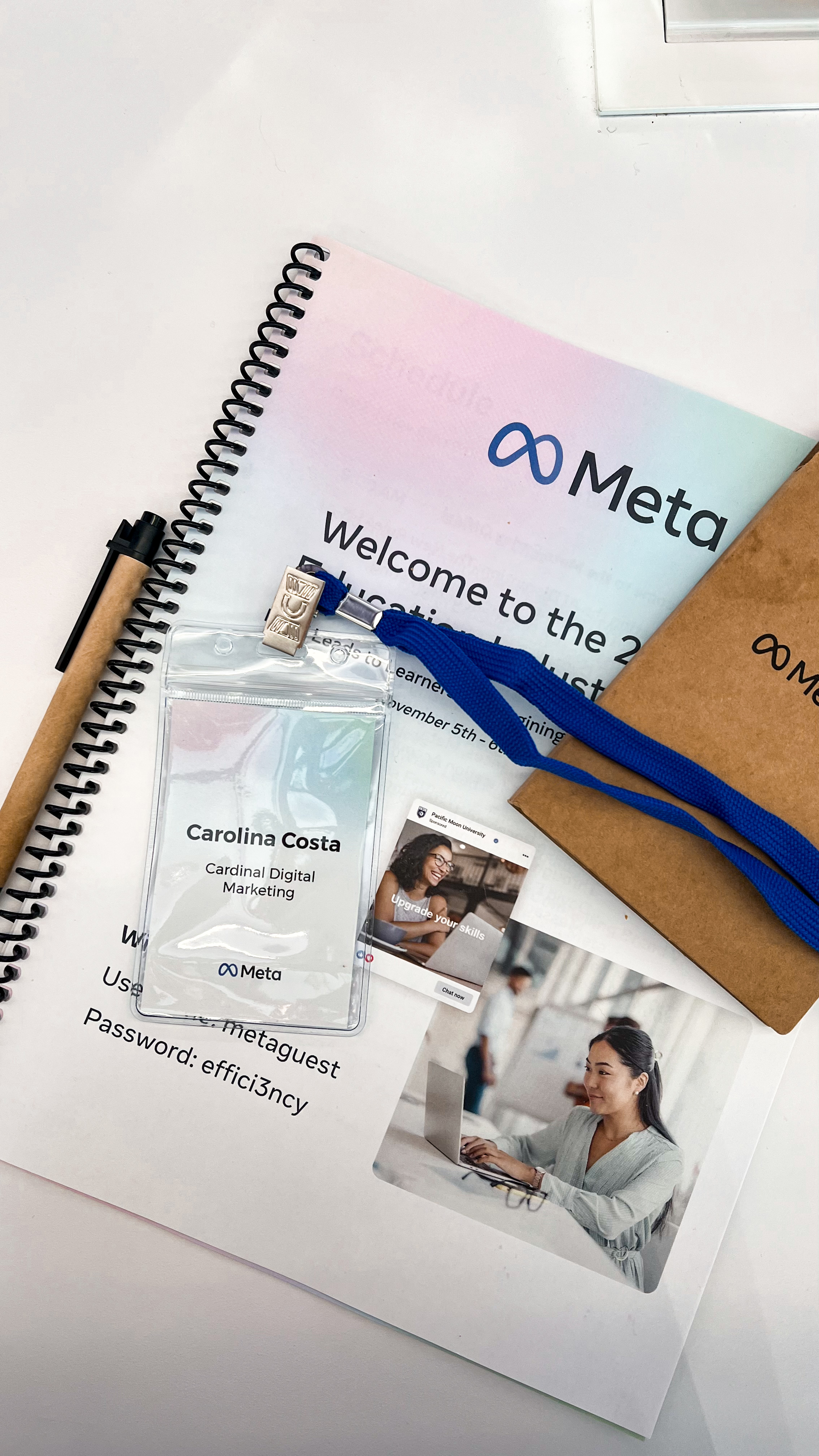Notebook, badge, and welcome packet from a Meta educational summit for Carolina Costa